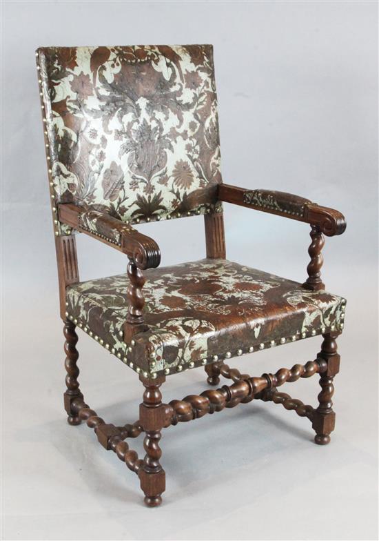 A 17th century style Italian oak open armchair, with painted embossed leather upholstery